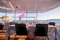 Luxurious yacht dining setup with ocean view, Custom Compositeworks 2006 model.