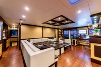 Luxurious yacht interior with modern design, Custom Compositeworks 2006, featuring elegant seating and wood flooring.