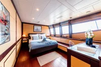 Luxurious yacht bedroom with modern decor, large windows, and elegant furnishings, Custom Compositeworks 2006.