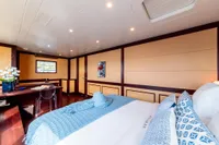Luxurious yacht bedroom with elegant decor, featuring a cozy bed and stylish furnishings, 2006 Compositeworks.