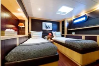 Luxurious yacht cabin with twin beds, modern decor, and ambient lighting, Custom Compositeworks 2006.