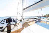 Luxurious 2006 Custom Compositeworks yacht deck with steering wheel, sailing on open sea.
