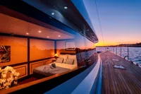 Luxurious 2006 Custom Compositeworks yacht at sunset, featuring elegant interior and scenic ocean view.