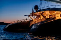 Luxurious 2006 Custom Compositeworks yacht at sunset on tranquil waters.