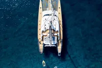 Aerial view of a 2006 Custom Compositeworks yacht anchored in clear blue water.