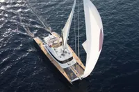 Aerial view of a 2006 Custom Compositeworks sailboat navigating the ocean.
