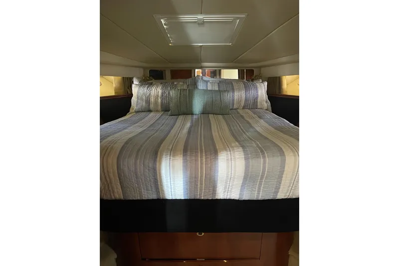  Yacht Photos Pics Cozy bedroom interior of 2003 Sea Ray 550 Sundancer yacht with striped bedding.