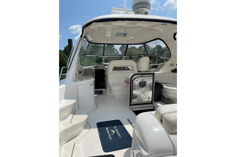 Yacht Photos Pics 2003 Sea Ray 550 Sundancer yacht interior with seating and helm, under a clear sky.