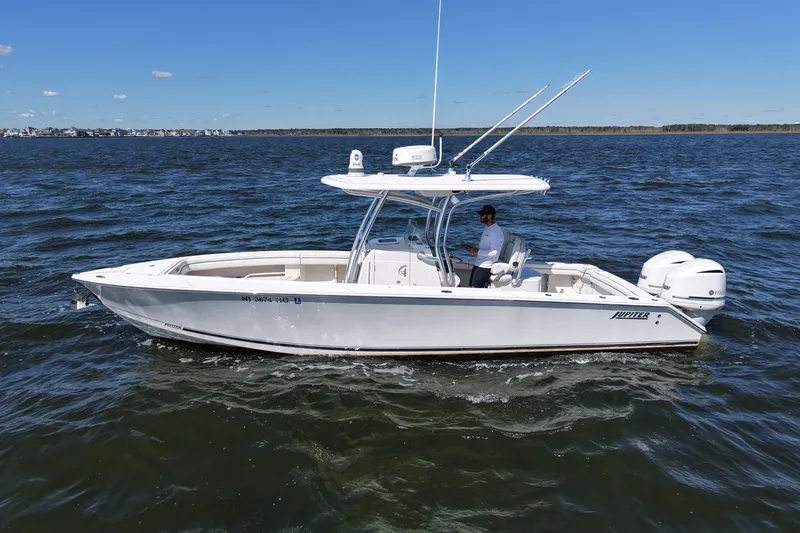  Yacht Photos Pics 2014 Jupiter 30 FS boat cruising on open water under clear blue sky.