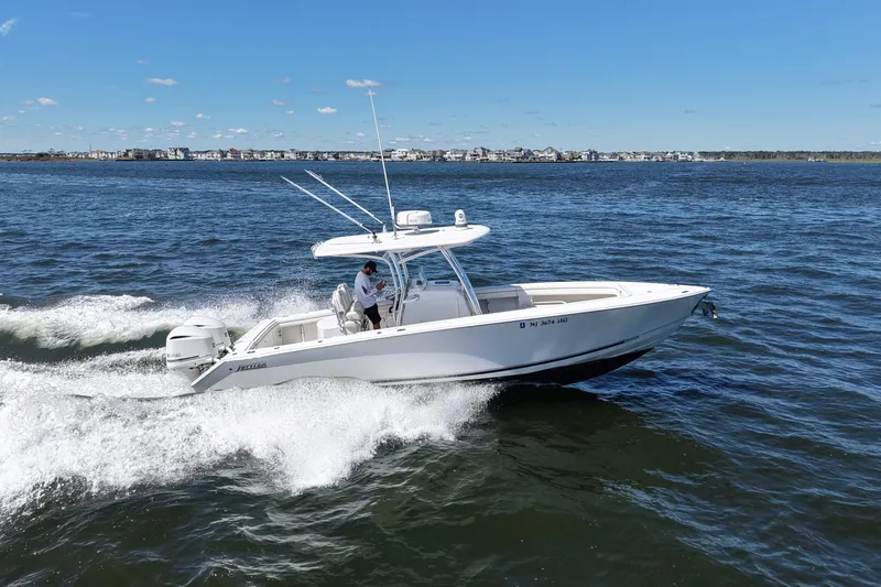  Yacht Photos Pics 2014 Jupiter 30 FS boat cruising on open water under clear blue skies.