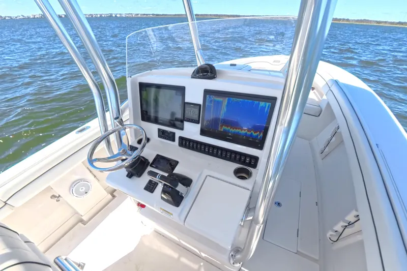  Yacht Photos Pics 2014 Jupiter 30 FS boat console with navigation screens on open water.