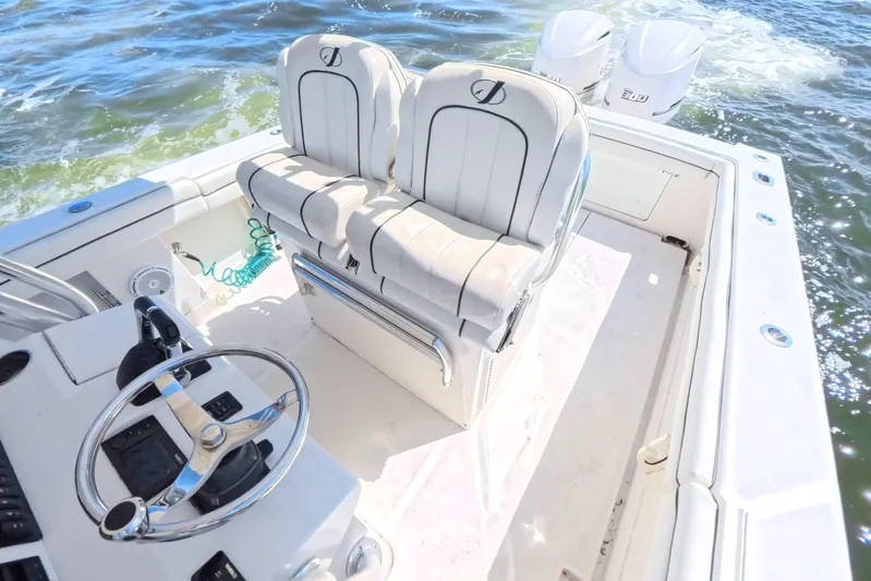  Yacht Photos Pics 2014 Jupiter 30 FS boat interior with dual seats and steering wheel on open water.