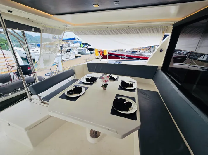 Cynthia Mae Yacht Photos Pics Luxurious dining area on a 2018 Leopard 45 yacht, elegantly set for four.