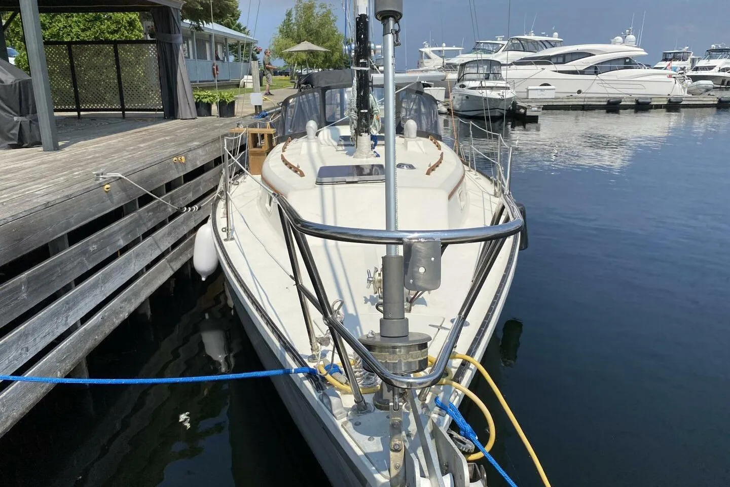 1984 Aloha 34 sailboat docked at marina, surrounded by other boats.