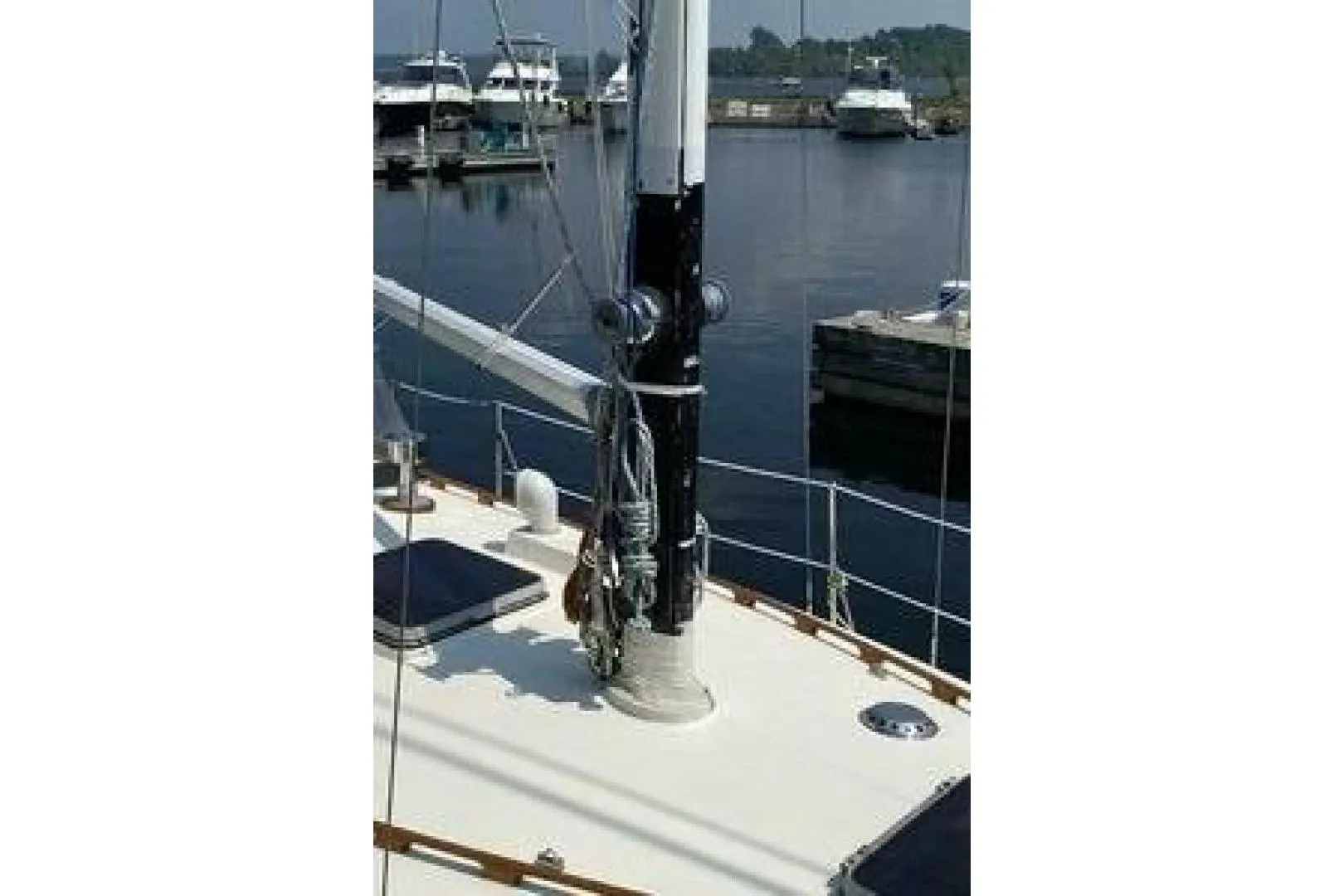 1984 Aloha 34 sailboat deck with mast, docked at marina.