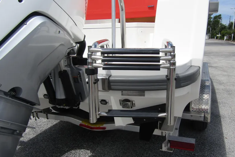  Yacht Photos Pics 2024 Nimbus T8 boat with stainless steel ladder and outboard motor on trailer.