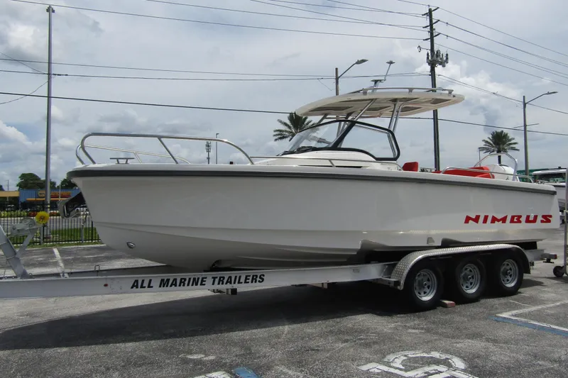  Yacht Photos Pics 2024 Nimbus T8 boat on trailer in parking lot, side view.
