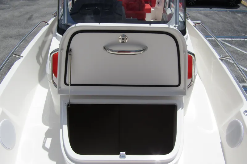  Yacht Photos Pics 2024 Nimbus T8 boat with open storage compartment, sleek design, and modern features.