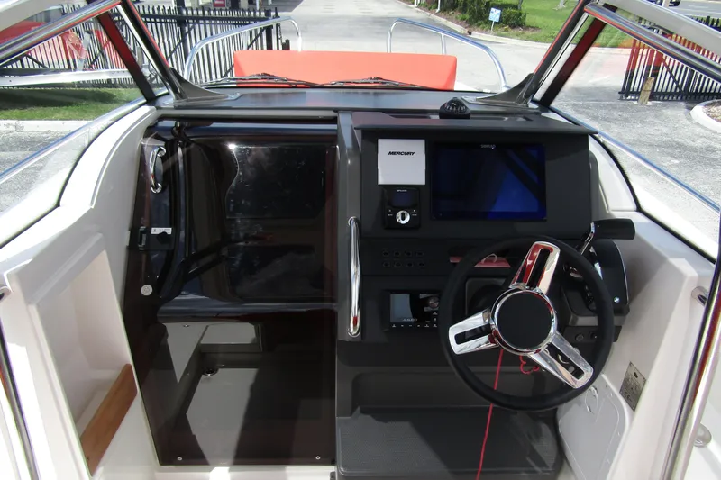  Yacht Photos Pics 2024 Nimbus T8 boat cockpit with modern steering and navigation controls.