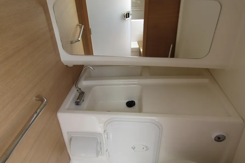  Yacht Photos Pics 2024 Nimbus T8 boat bathroom with sink, mirror, and wooden accents.