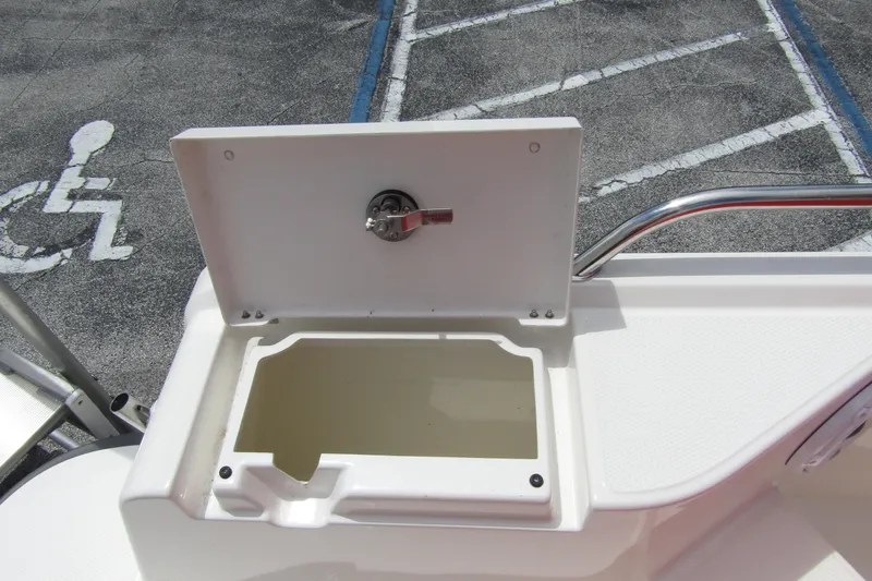  Yacht Photos Pics Open storage compartment on 2024 Nimbus T8 boat, with latch and railing.