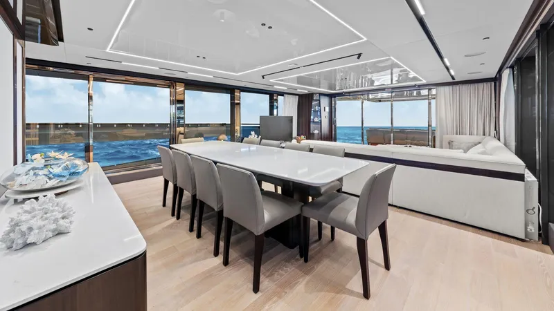 Contessa Yacht Photos Pics Luxurious interior of 2024 Sunseeker 100' Yacht with ocean view, elegant dining and seating area.