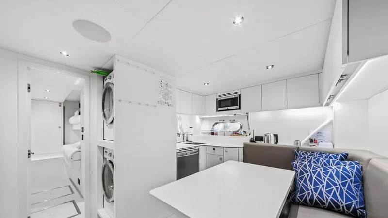 Contessa Yacht Photos Pics Luxurious interior of 2024 Sunseeker 100' Yacht featuring modern kitchen and dining area.