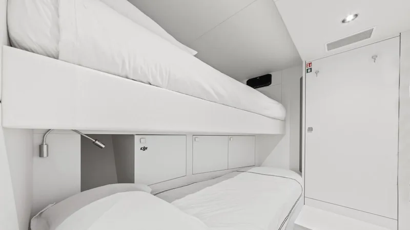 Contessa Yacht Photos Pics Luxurious 2024 Sunseeker 100' Yacht cabin with modern white bunk beds.