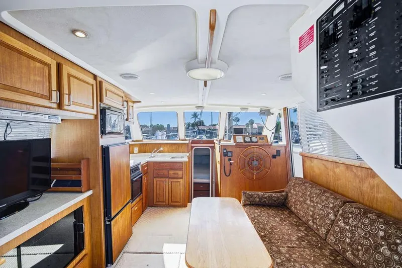 Yacht Photos Pics Interior of 1998 Mainship 350 Trawler with wood cabinetry and helm station.