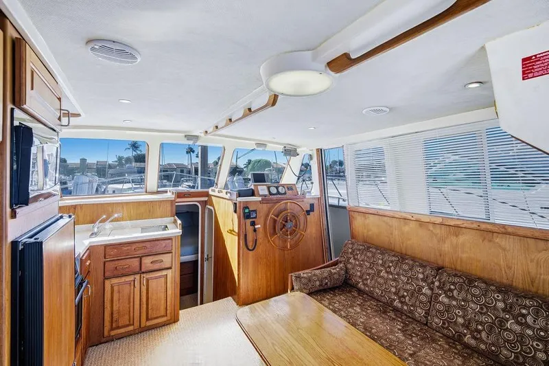  Yacht Photos Pics Interior of 1998 Mainship 350 Trawler with wood finishes and nautical decor.