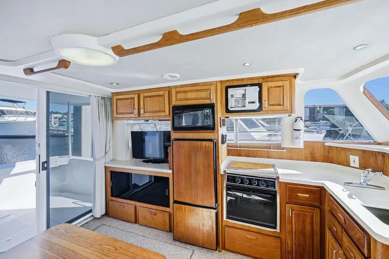  Yacht Photos Pics Interior of 1998 Mainship 350 Trawler with kitchen, appliances, and wood cabinetry.