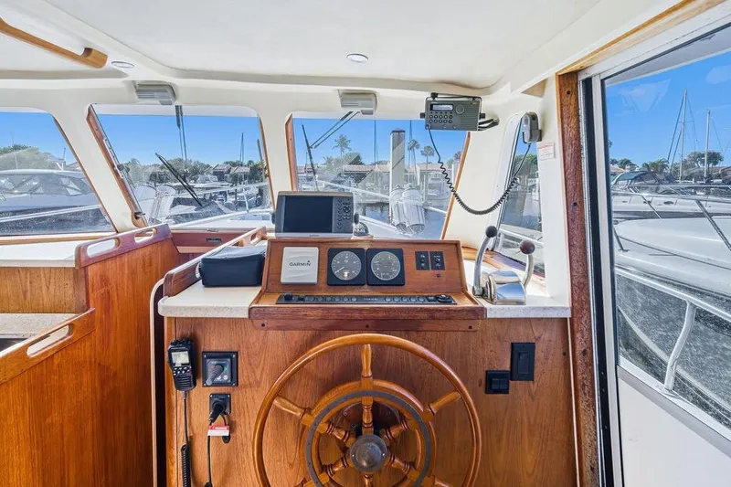  Yacht Photos Pics 1998 Mainship 350 Trawler helm with wooden wheel and navigation equipment.