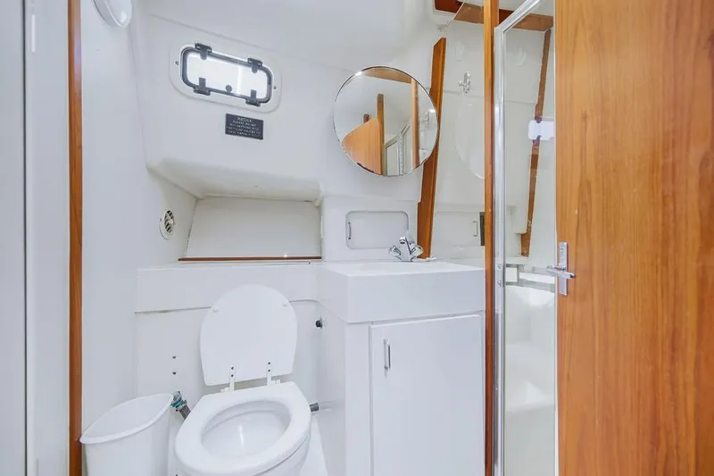  Yacht Photos Pics 1998 Mainship 350 Trawler bathroom with toilet, sink, and shower.