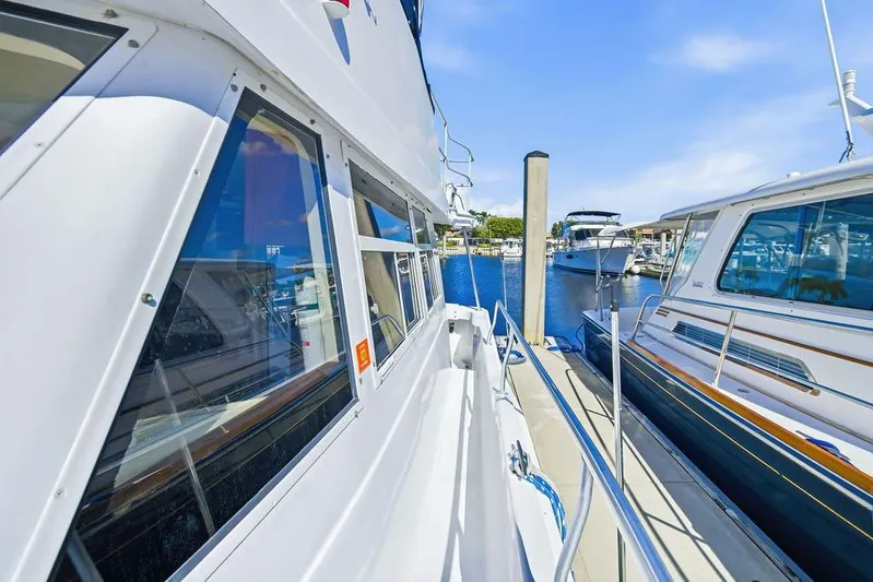 Yacht Photos Pics 1998 Mainship 350 Trawler docked at marina, showcasing sleek design and spacious deck.