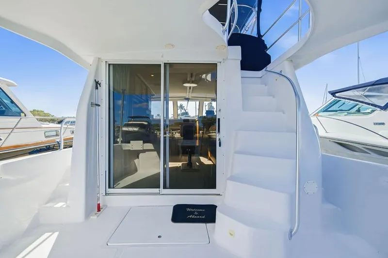  Yacht Photos Pics 1998 Mainship 350 Trawler yacht with white exterior and sliding glass door.