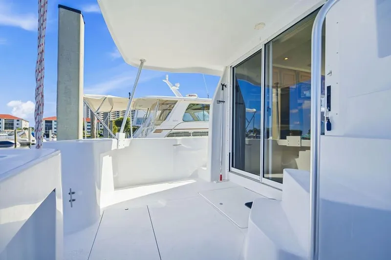  Yacht Photos Pics 1998 Mainship 350 Trawler deck with sliding glass doors and marina view.