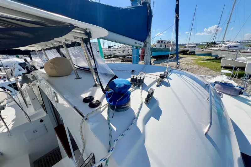 Still Got It Yacht Photos Pics Lagoon 380 catamaran deck view, 2002 model, docked with clear blue sky.