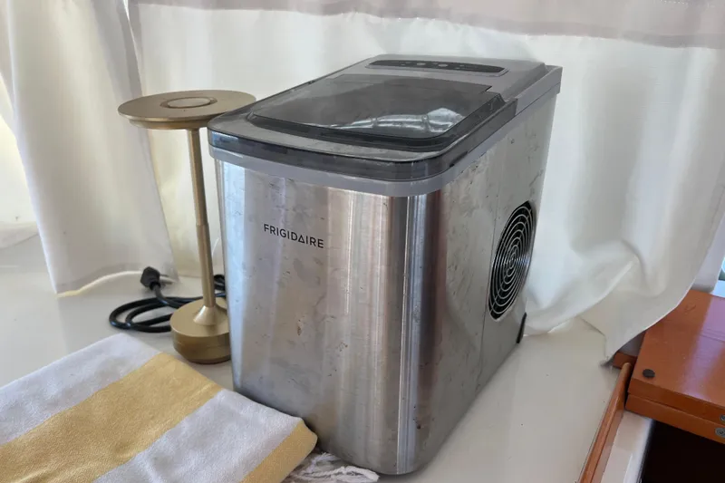 Still Got It Yacht Photos Pics Frigidaire ice maker on Lagoon 380 yacht, 2002 model, with lamp and towel nearby.