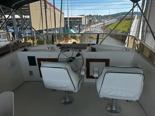 Westwind Yacht Photos Pics Helm of 2004 Westcoast 46 yacht with dual white captain chairs and steering wheel.