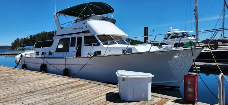 Westwind Yacht Photos Pics A 2004 Westcoast 46 yacht docked at a marina under a clear blue sky.