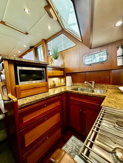 Westwind Yacht Photos Pics Luxurious 2004 Westcoast 46 yacht kitchen with granite countertops and modern appliances.
