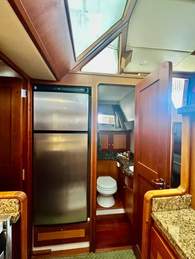 Westwind Yacht Photos Pics Luxurious 2004 Westcoast 46 yacht interior with kitchen and bathroom, featuring wood finishes and modern appliances.