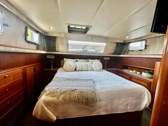 Westwind Yacht Photos Pics Luxurious bedroom interior of 2004 Westcoast 46 yacht with elegant wood finish and cozy bedding.