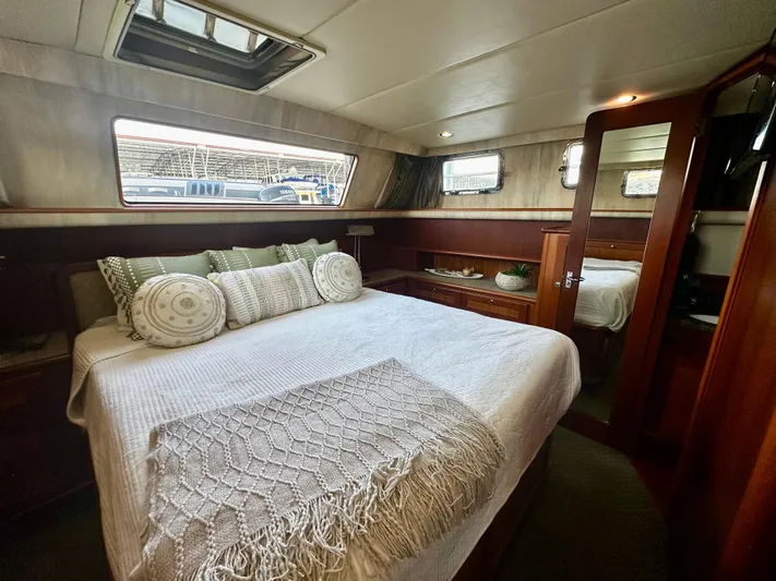 Westwind Yacht Photos Pics Luxurious 2004 Westcoast 46 yacht bedroom with cozy bedding and elegant wood finishes.