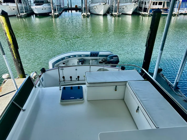 Westwind Yacht Photos Pics Luxurious 2004 Westcoast 46 yacht deck with seating, docked at marina.