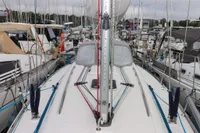 Dufour 40 Performance 2007 sailboat docked among other boats in a marina.