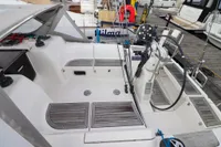 Cockpit of 2007 Dufour 40 Performance sailboat, featuring teak flooring and steering wheel.