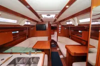 Interior of 2007 Dufour 40 Performance yacht with wood finish and cozy seating area.