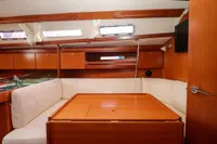 Interior of 2007 Dufour 40 Performance yacht with wooden furnishings and cozy seating area.