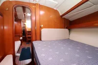 2007 Dufour 40 Performance yacht interior with cozy wooden cabin and comfortable bedding.